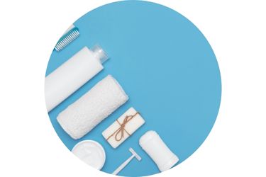 White hygiene products (deodorant, razor, various soaps) on a light blue background