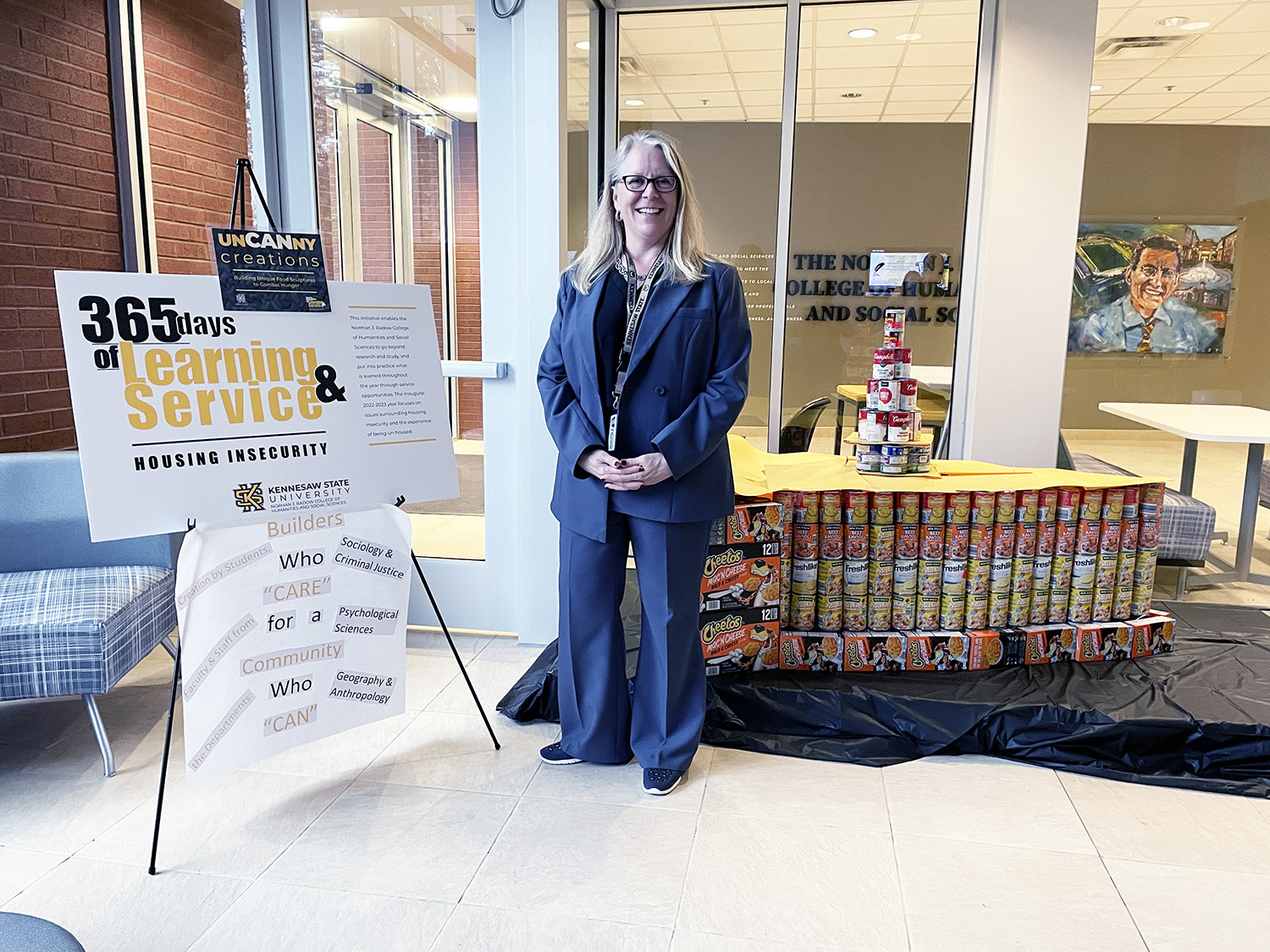 Dean Kaukinen in front of the winning sculpture of "UnCANny Creations 2022," a piece of pie built by students, staff, and faculty.