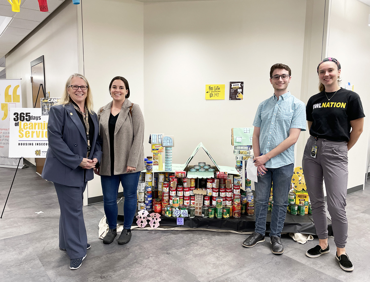Dean Kaukinen with the runner up team in front of their can structure.