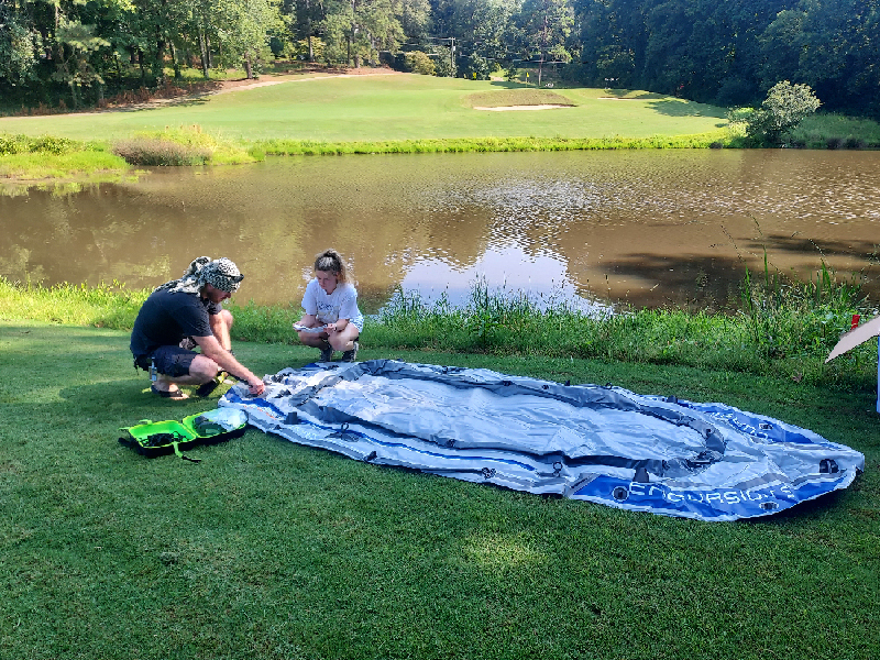 Students Tristan Bollenbaugh and Keely Gerety at lake inflating raft