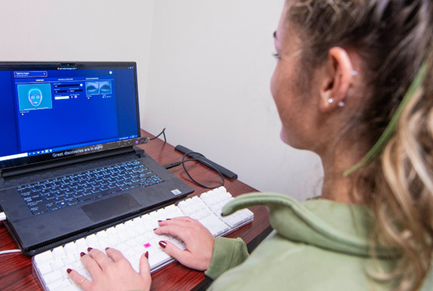 KSU undergraduate student Hopie Schlenker sitting at a computer.