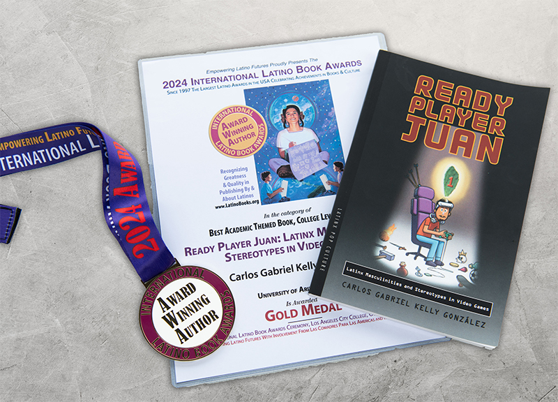 Image of the medal for the 2024 International Latino Book Awards, and a copy of his winning book "Ready Player Juan" along with the certificate from the organization:Empowering Latino Futures Gold Medal in the Catageory of Best Academic Themed Book, College Level