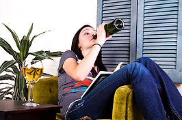 Girl drinking beer while studying