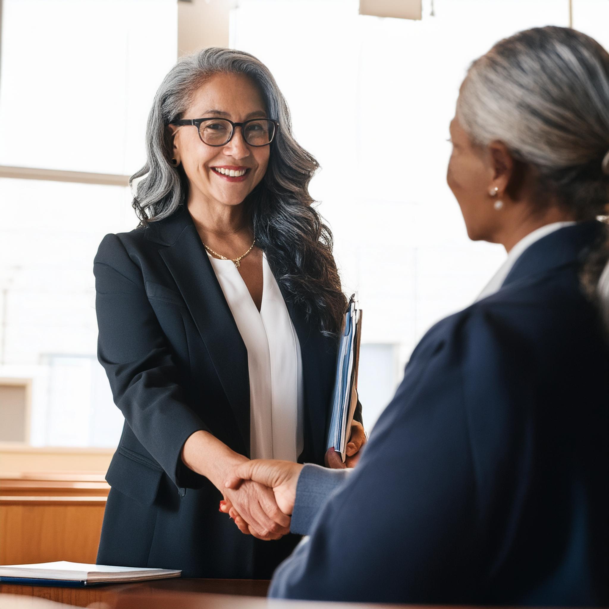 Faculty member shaking hands with supervisor